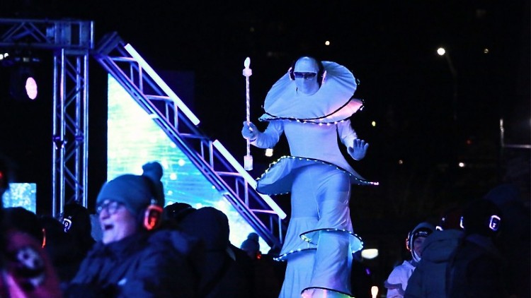 A stilts performer dances in the crowd at the 2025 World of Winter Festival silent disco on Jan. 18, 2025