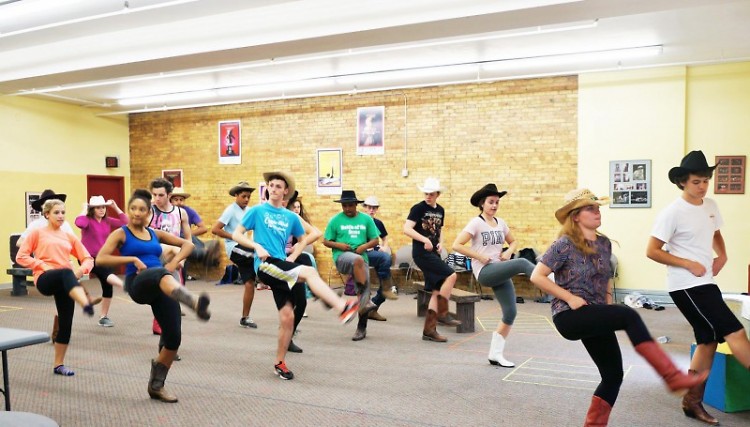 Students run through a "Footloose" dance number.