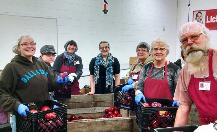 Maggie Marcinkus, center, with a group of volunteers at Feeding America West Michigan.