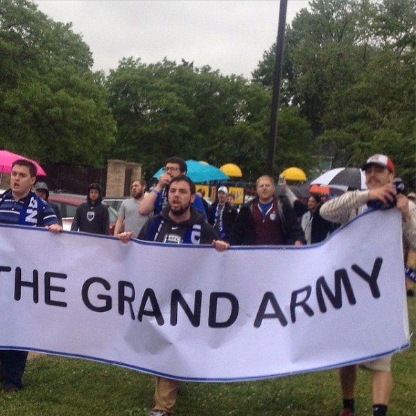 Members of the Grand Army, the fan support group of Grand Rapids Football Club, march to a game at Houseman Field.