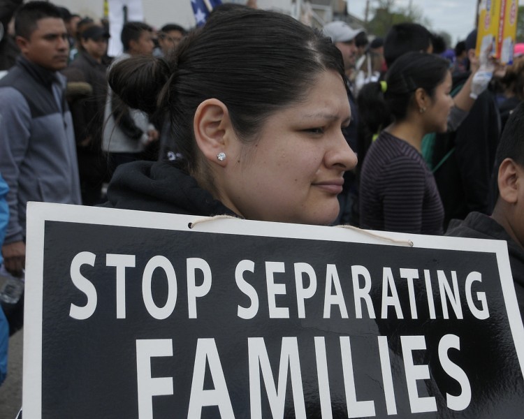 Marcher with a "Stop Separating Families" sign at the "A Day Without Immigrants" march.