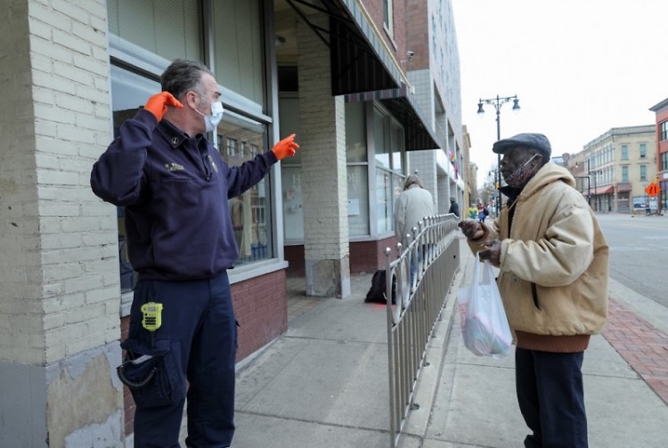 Fire Capt. Mike Waldron, HOT member, talking with a pedestrian on Division Ave. S.