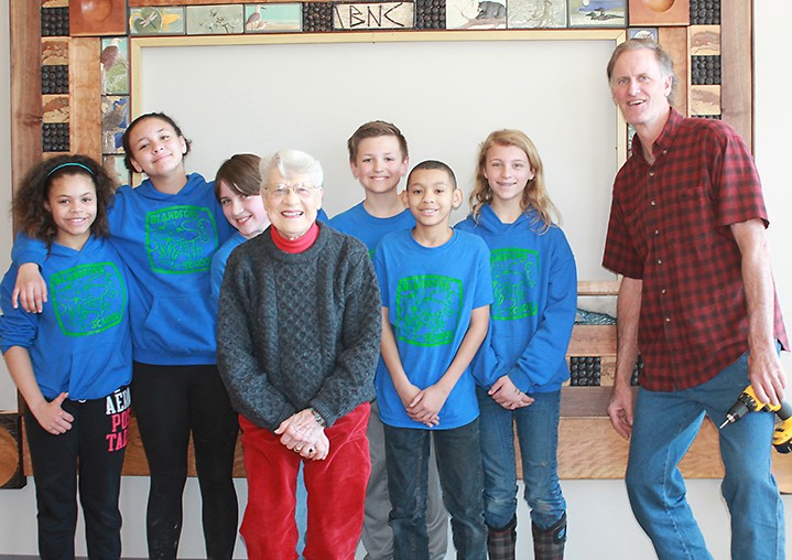 Mary Jane Dockeray and students from nearby Blandford School helped install the donor wall with Jeff Lende, an artist and former