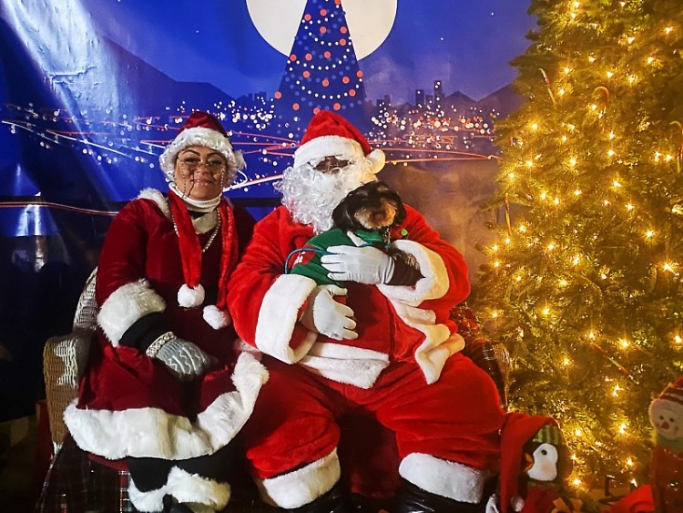 Rashell (left) and James Ross of Grand Rapids reprise their rolls as the Boston Square Santa and Mrs. Clause for the second year