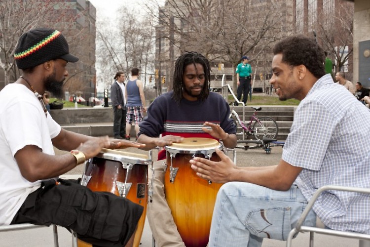Kamau Re'xi, Manchurian Bell, and Herb Wise play bongos in Rosa Parks Circle