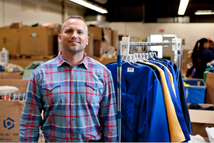 Seth Yon poses in the sorting warehouse at Goodwill on 29th Street