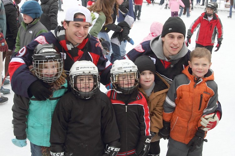 Griffins players Francis Pare and Brendan Smith with young fans