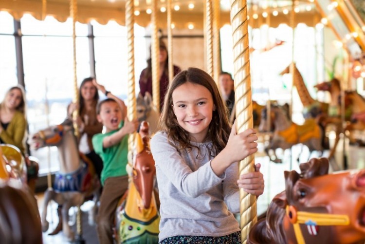 A museum attendee enjoys the carousel.