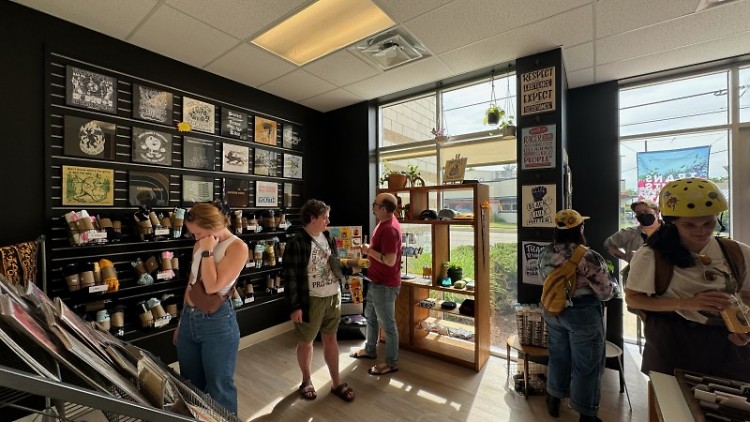 Shoppers visit Transfigure Print Shop on opening day, June 1, 2024