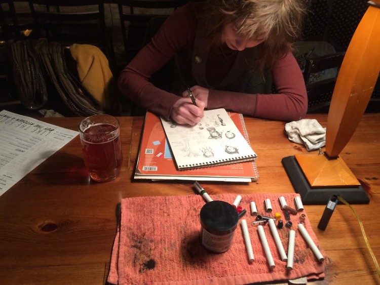 Kat Ehlich works on ink sketches.