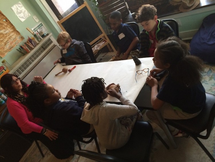 Young writers exploring artifacts for inspiration at the Creative Youth Center