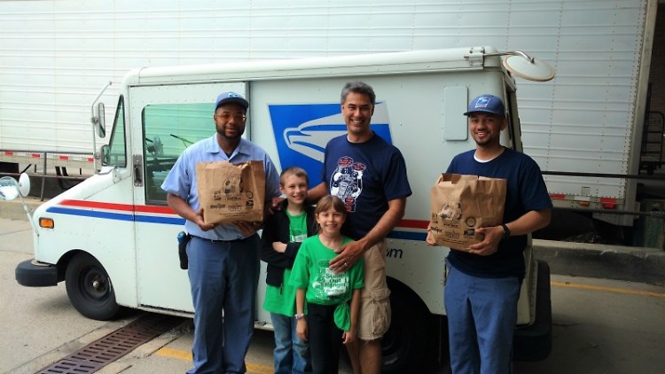Letter carriers and helpers display donated food at the Kentwood Post Office branch, Saturday, May 13.