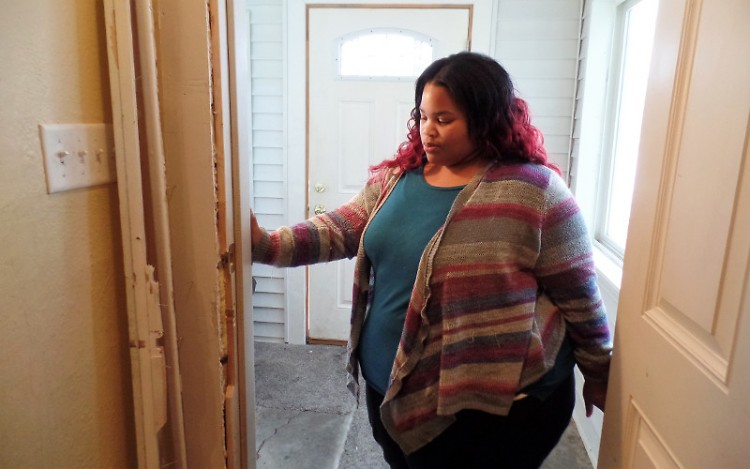 Lisa Wilkerson shows the damage to door entering her living area.
