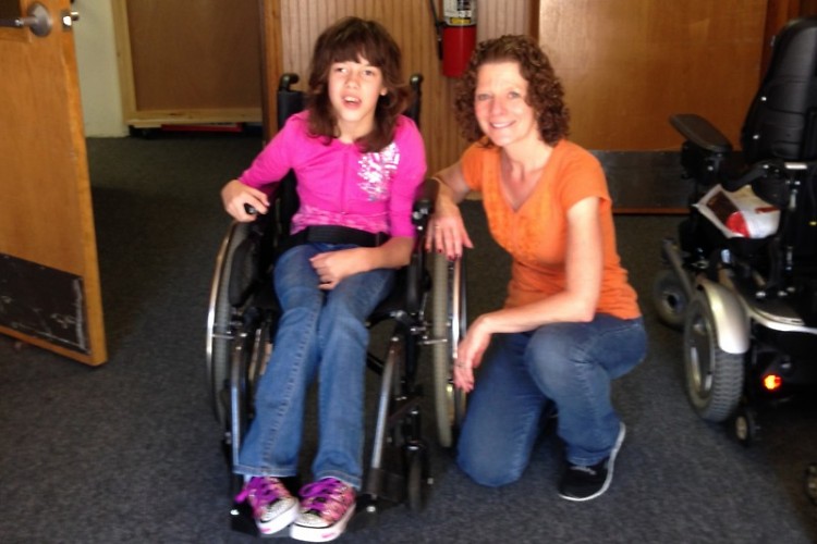 These awards raise funds to help wheelchair recipients like Lizzy (pictured with staff member Liz).