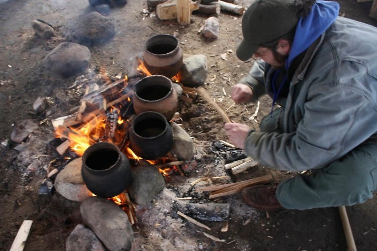 Erik Vosteen boils maple sap at Blandford Nature Center in unglazed pottery.