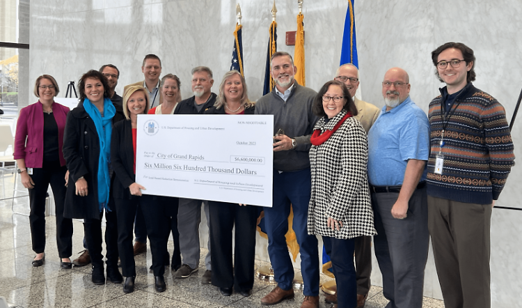 City of Grand Rapids staff pose with the ceremonial check from the U.S. Department of Housing and Urban Development