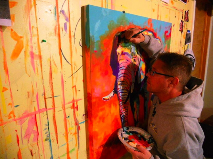 David Warmenhoven works on a painting