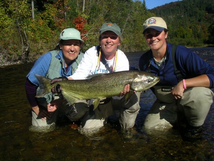 From left, Rosanna Laude, Ann Miller and Jenn Nelson are all smiles as they hold a Chinook salmon.