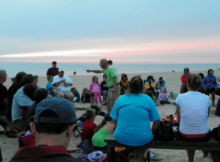 Warren Dunes State Park Explorer Guide Mike Latus tells a campfire story on the beach. 
