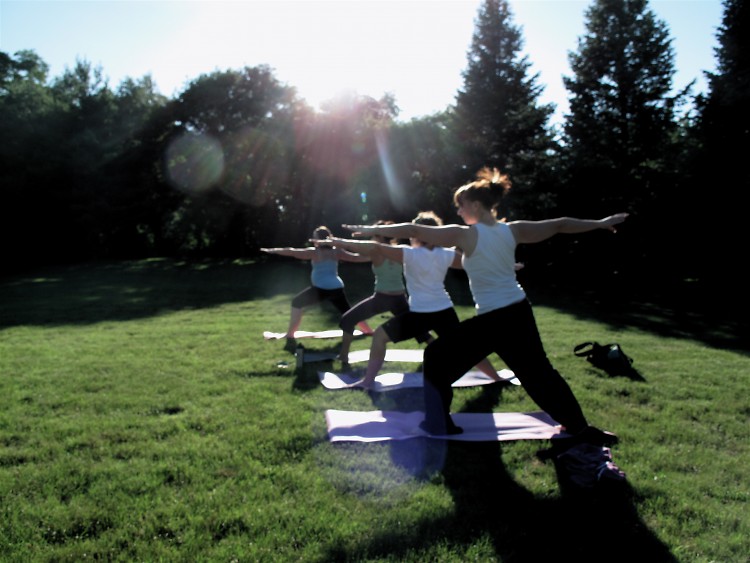 Students hold a variation of warrior pose.