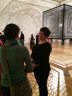Anila Quayyum Agha chatting with fans in front of her piece, Intersections.