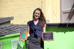 Autumn Sands shows off awards garnered for BarFly's efforts in sustainability
