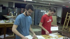 Society members Drew Damron (L) and Brian Boss (R) assemble zines.