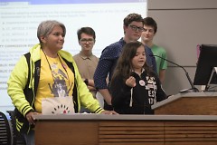 Gema Lowe supporting a young speaker at Tuesday's City Commission meeting.