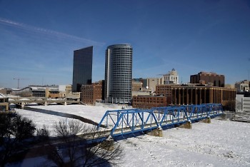 A view of the Grand River covered in ice; the buildings of downtown Grand Rapids are visible in the background