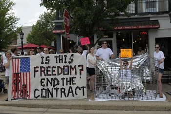 Movimiento Cosesha GR protests Kent County's contract with ICE at East Grand Rapids' parade
