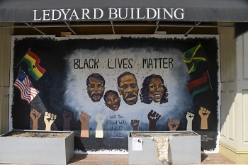 Mural along downtown Grand Rapids' Monroe Center St. of the faces of lives lost to racially-based police brutality.