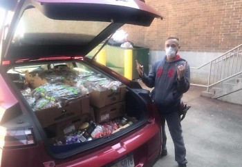 Dave Cobb, manager at one of Grand Rapids' Aldi stores, donating food to the Grand Rapids Service Industry Network (GRSIN).