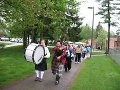 Bagpipers lead the 2k Big Step Walk through Aquinas College Campus.