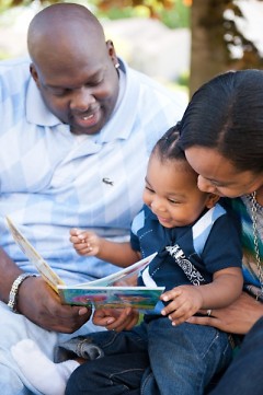 Kevin and Trinity Clemens read to their son, Zion.