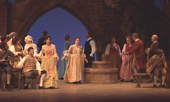 Kristen Burghart (center, by the well) plays the part of a Madrigal Singer.