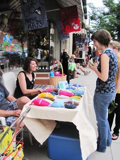 Artist and vendor Taylor Greenfield converses with a Market goer.