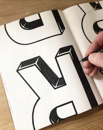 Battjes inking the letter 'R.'