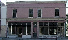Neglected building prior to re-investment, now home to Rowster's Coffee, a neighborhood grown business.