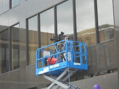 Volunteer Camera Operator Alexis Ashcroft ontop of scissor lift operating camera number two