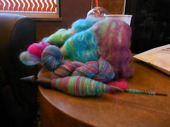 One knitters spinning project sits on a table.