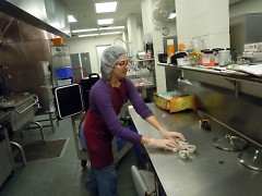 Feeding America West Michigan staff member Elianna Bootzin prepares recipe samples before an April distribution.