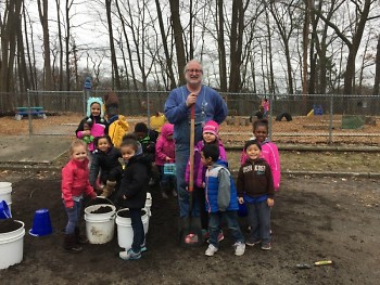 Preschoolers pose with Jeff Smith from Gardens for Grand Rapids who helped them build their garden