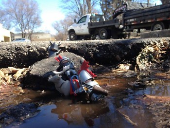 Gretchen Vinnedge used figurines to create an "escape" scene in a pothole near her office.