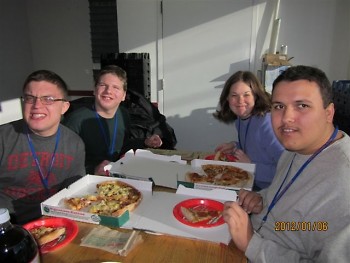(L to R) Alex Pusztal, Michael Bronkema, Kristen Barnikow and Nick Evans enjoy their pizzas during  their tour of Papa John's
