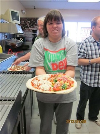 Katie Miller holds her pizza she made as part of the classroom tour.