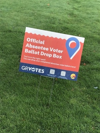 An absentee voter ballot drop box yard sign.