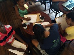 Attendees of the CYC's Summer Safari program direct their creative thoughts to the page at Sparrows Coffee Tea & Newstand