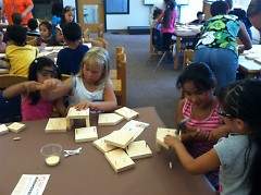 Kindergartners team up with second graders to build the birdhouses.