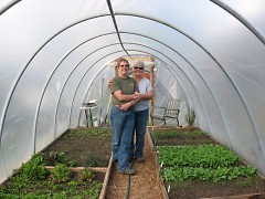 Lane and Sanwald in one of their hoophouses at Brickyard Farms. 