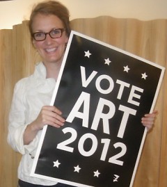 Amelea Pegman poses with ArtPrize 2012 sign, available to purchase for 5 dollars.
